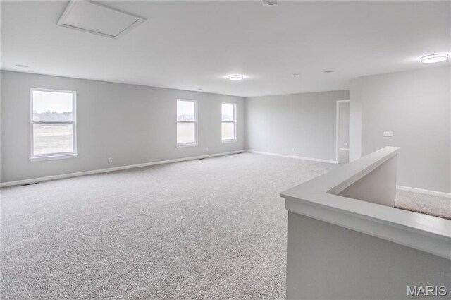 spare room with carpet and baseboards