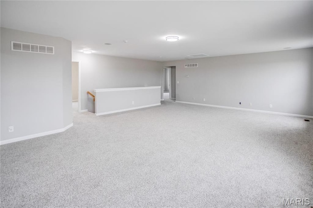 below grade area featuring light carpet and baseboards