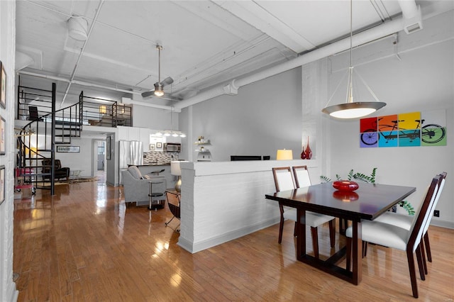 4100 Laclede Ave Unit 310, Saint Louis, MO 63108 - dining room featuring wood finished floors, stairway, and a high ceiling