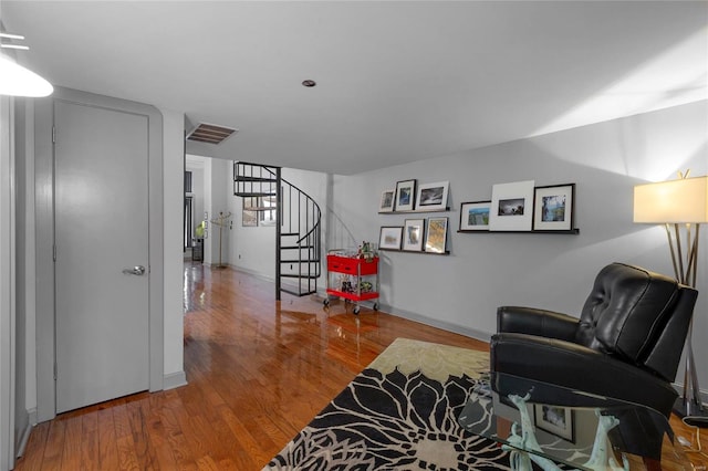 4100 Laclede Ave Unit 310, Saint Louis, MO 63108 - sitting room featuring wood finished floors, stairs, and baseboards