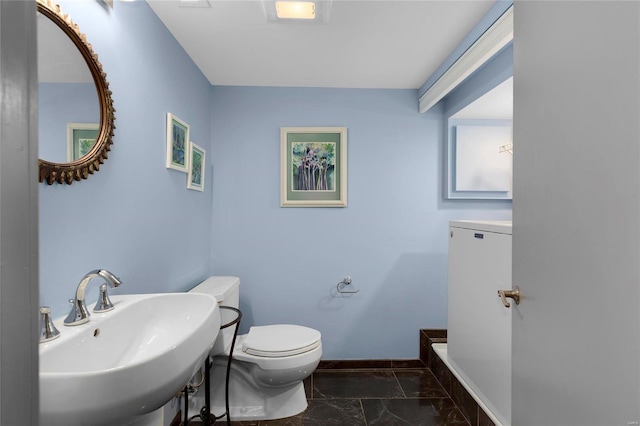 4100 Laclede Ave Unit 310, Saint Louis, MO 63108 - bathroom featuring marble finish flooring, baseboards, a sink, and toilet