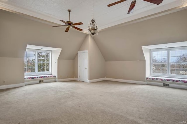 additional living space with a ceiling fan, carpet, plenty of natural light, and vaulted ceiling