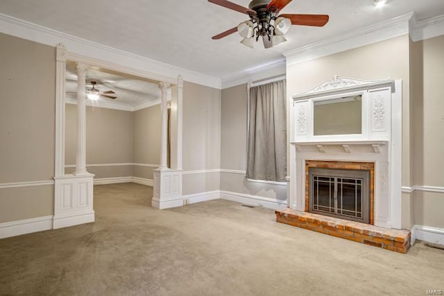 unfurnished living room with a ceiling fan, crown molding, decorative columns, carpet floors, and a brick fireplace