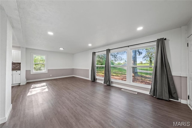 1919 Parker Rd, Saint Louis, MO 63138 - unfurnished living room with dark wood-type flooring, baseboards, and recessed lighting