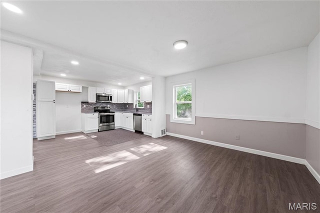 1919 Parker Rd, Saint Louis, MO 63138 - unfurnished living room with baseboards, recessed lighting, and dark wood-style flooring