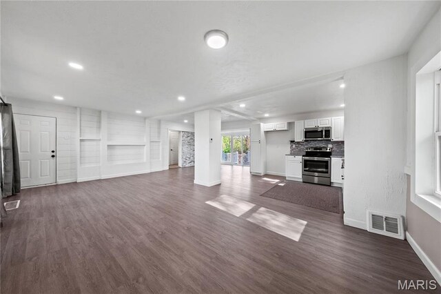 1919 Parker Rd, Saint Louis, MO 63138 - unfurnished living room featuring baseboards, dark wood-style floors, and recessed lighting