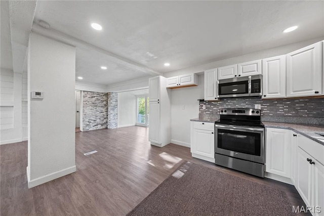 1919 Parker Rd, Saint Louis, MO 63138 - kitchen featuring appliances with stainless steel finishes, baseboards, tasteful backsplash, dark wood-style floors, and recessed lighting