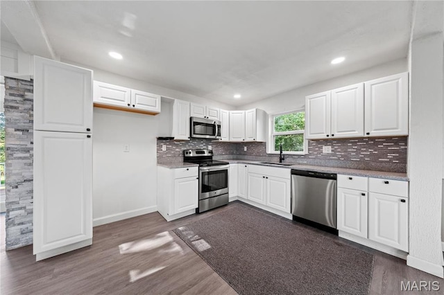 1919 Parker Rd, Saint Louis, MO 63138 - kitchen with appliances with stainless steel finishes, a sink, backsplash, white cabinetry, and baseboards
