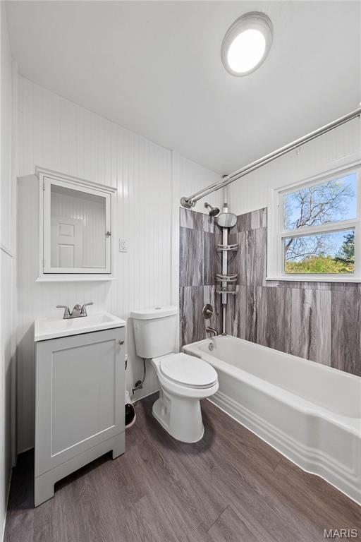 1919 Parker Rd, Saint Louis, MO 63138 - bathroom featuring shower / bath combination, wood finished floors, vanity, and toilet
