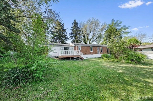 1919 Parker Rd, Saint Louis, MO 63138 - back of house featuring a deck, a lawn, and brick siding