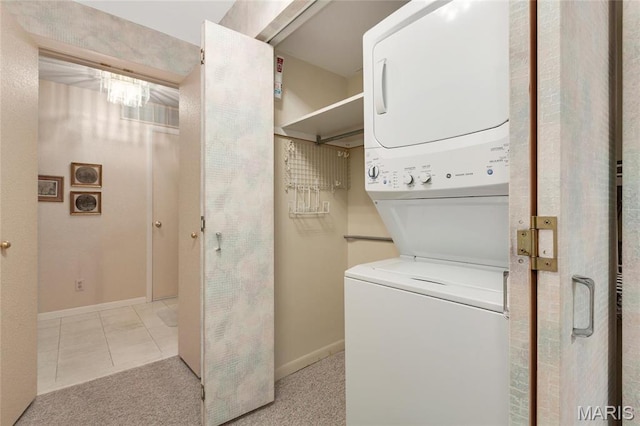 585 Coeur De Royale Dr Unit 206, Creve Coeur, MO 63141 - washroom with estacked washer and dryer and light tile patterned floors