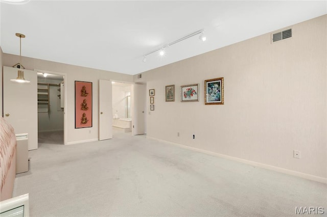 585 Coeur De Royale Dr Unit 206, Creve Coeur, MO 63141 - unfurnished bedroom with carpet, a walk in closet, track lighting, ensuite bathroom, and a closet