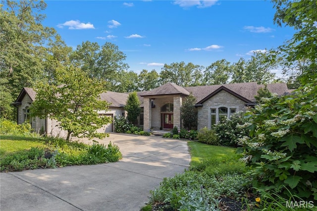140 Norfork Ct, Defiance, MO 63341 - view of front of property featuring driveway, stone siding, and a garage