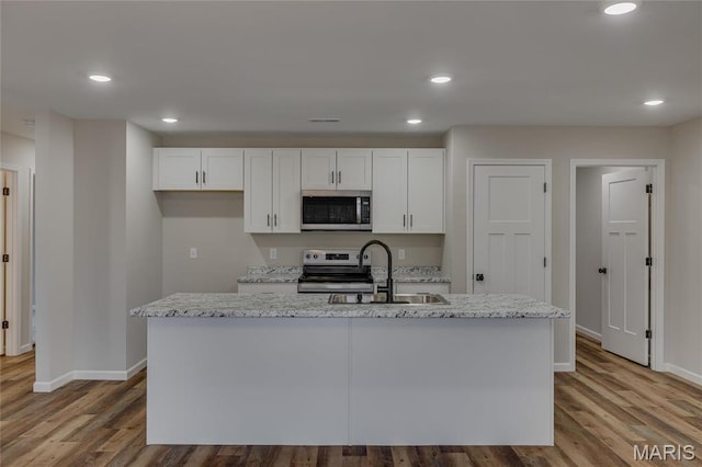 506 S Cantwell Ln, Desloge, MO 63601 - kitchen with appliances with stainless steel finishes, a sink, baseboards, white cabinetry, and recessed lighting