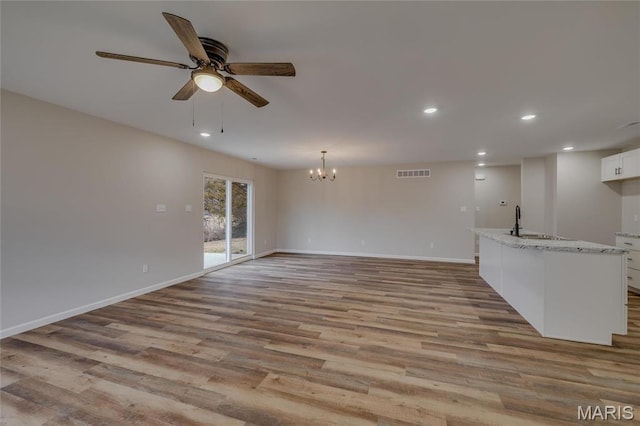 506 S Cantwell Ln, Desloge, MO 63601 - unfurnished living room featuring recessed lighting, a sink, light wood finished floors, ceiling fan, and baseboards