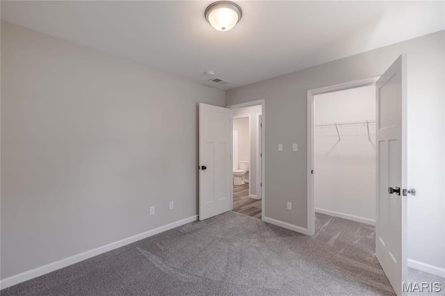 506 S Cantwell Ln, Desloge, MO 63601 - unfurnished bedroom featuring carpet flooring, baseboards, a walk in closet, and a closet
