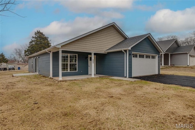 506 S Cantwell Ln, Desloge, MO 63601 - view of front facade with a garage, driveway, a porch, and a front lawn