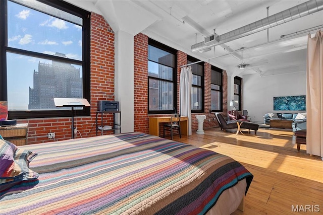 1010 Saint Charles St Unit 904, Saint Louis, MO 63101 - bedroom featuring hardwood / wood-style flooring and brick wall