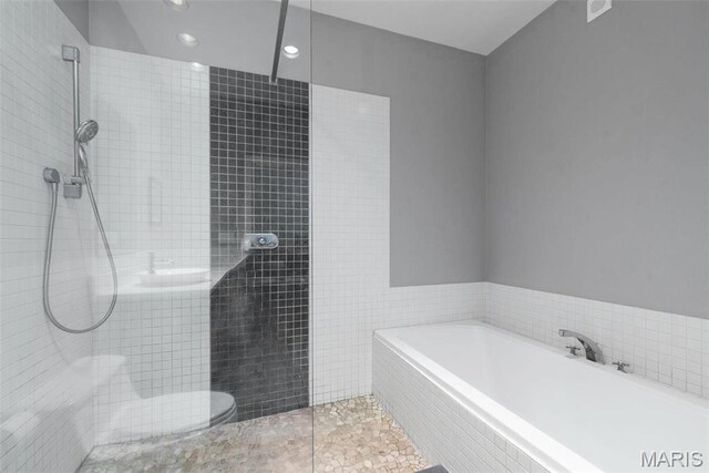 1010 Saint Charles St Unit 904, Saint Louis, MO 63101 - bathroom with a garden tub, a walk in shower, and recessed lighting