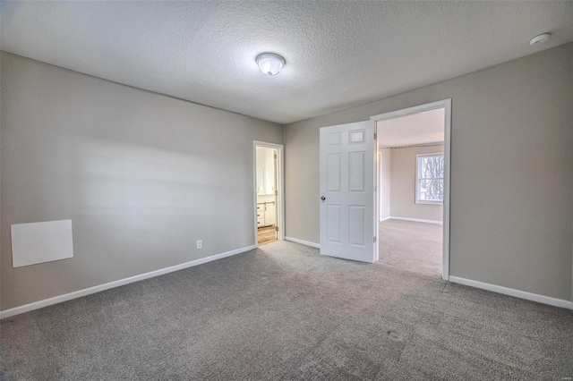 1311 Beck, Lebanon, MO 65536 - empty room with carpet, baseboards, and a textured ceiling