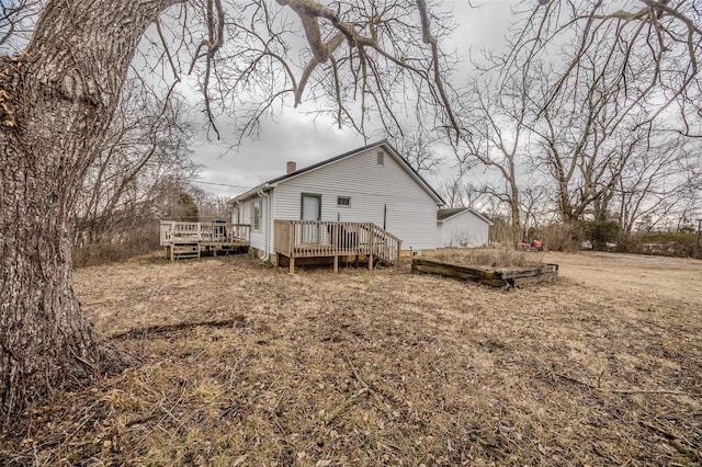 1311 Beck, Lebanon, MO 65536 - back of house with a chimney and a wooden deck