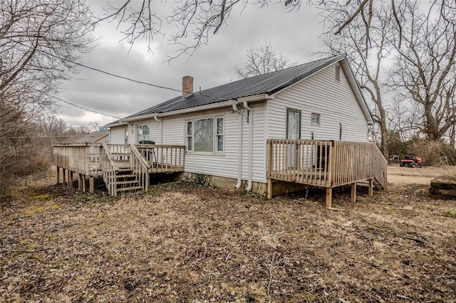 1311 Beck, Lebanon, MO 65536 - rear view of house featuring a wooden deck, metal roof, and a chimney