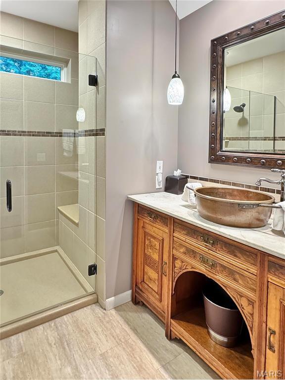 501 4th St W, Hermann, MO 65041 - full bathroom with a shower stall, vanity, and baseboards