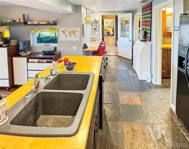 501 4th St W, Hermann, MO 65041 - kitchen featuring stone tile floors, a sink, and recessed lighting