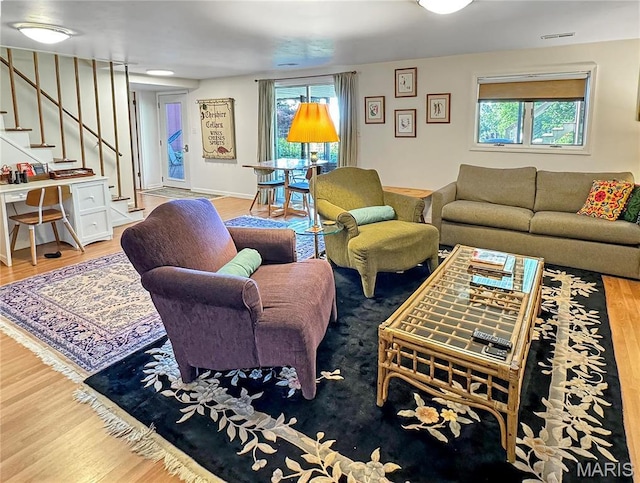 501 4th St W, Hermann, MO 65041 - living room featuring wood finished floors, healthy amount of natural light, and stairs
