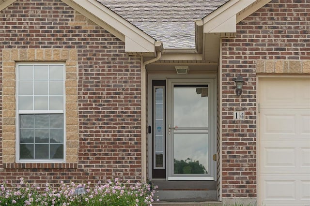 14 Club Ct, Union, MO 63084 - property entrance featuring a shingled roof, brick siding, and a garage