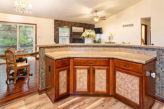 14 Club Ct, Union, MO 63084 - kitchen featuring lofted ceiling, light wood-type flooring, and brown cabinets