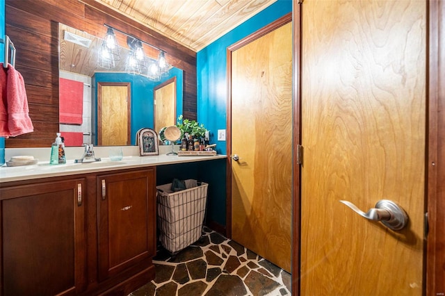 14 Club Ct, Union, MO 63084 - bathroom with stone finish floors, vanity, and wooden walls