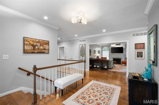 29 Spoede Ln, Creve Coeur, MO 63141 - corridor with crown molding, an upstairs landing, recessed lighting, wood finished floors, and a chandelier