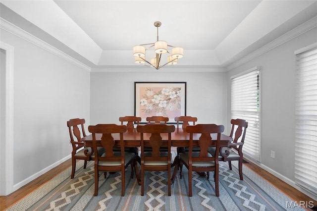 29 Spoede Ln, Creve Coeur, MO 63141 - dining space featuring a chandelier, a tray ceiling, and wood finished floors