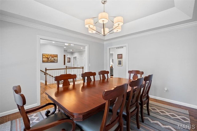 29 Spoede Ln, Creve Coeur, MO 63141 - dining area featuring a chandelier, wood finished floors, crown molding, recessed lighting, and a raised ceiling