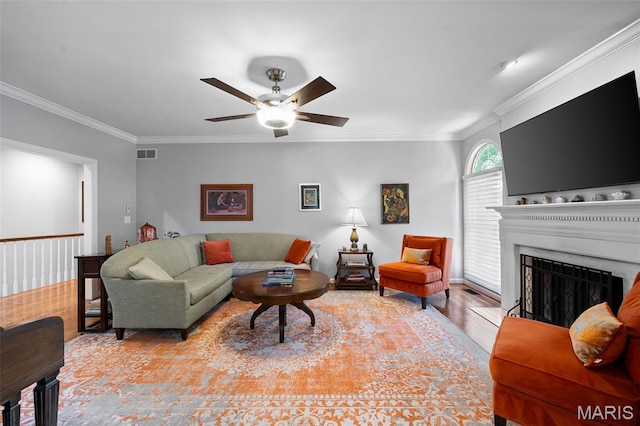 29 Spoede Ln, Creve Coeur, MO 63141 - living room with crown molding, a ceiling fan, wood finished floors, and a fireplace