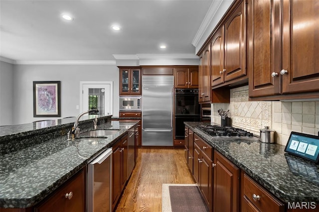 29 Spoede Ln, Creve Coeur, MO 63141 - kitchen with built in appliances, crown molding, light wood-style flooring, tasteful backsplash, and dark stone counters