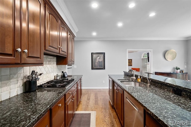 29 Spoede Ln, Creve Coeur, MO 63141 - kitchen featuring appliances with stainless steel finishes, ornamental molding, light wood-style floors, backsplash, and dark stone counters