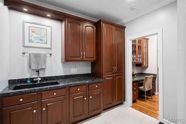 29 Spoede Ln, Creve Coeur, MO 63141 - kitchen featuring built in desk, ornamental molding, dark stone counters, and light tile patterned floors