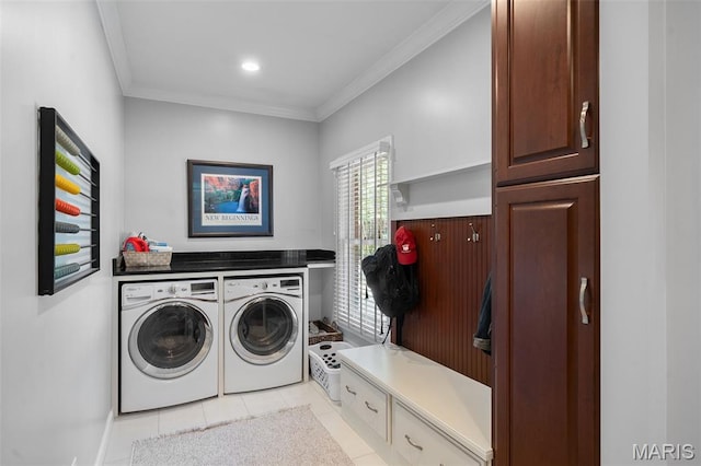 29 Spoede Ln, Creve Coeur, MO 63141 - laundry area featuring washing machine and clothes dryer, light tile patterned flooring, ornamental molding, and cabinet space