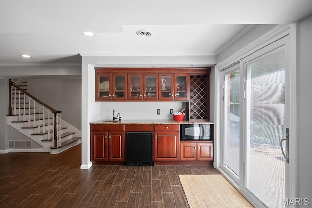 29 Spoede Ln, Creve Coeur, MO 63141 - indoor wet bar with crown molding, black microwave, stairway, dark wood-style floors, and recessed lighting