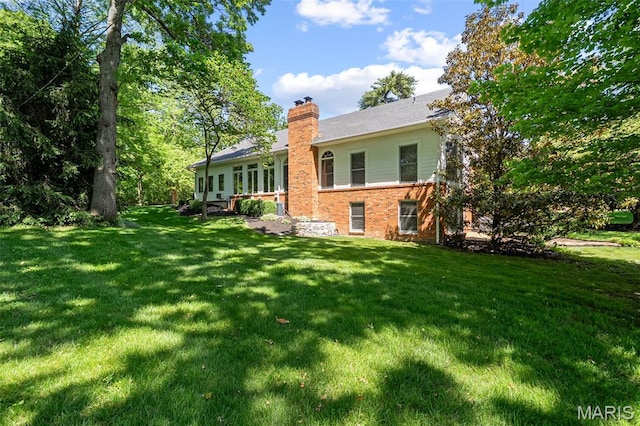 29 Spoede Ln, Creve Coeur, MO 63141 - back of house featuring brick siding, a chimney, and a yard