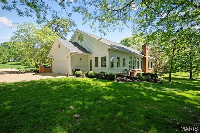 29 Spoede Ln, Creve Coeur, MO 63141 - view of home's exterior featuring driveway, a chimney, a yard, and an attached garage