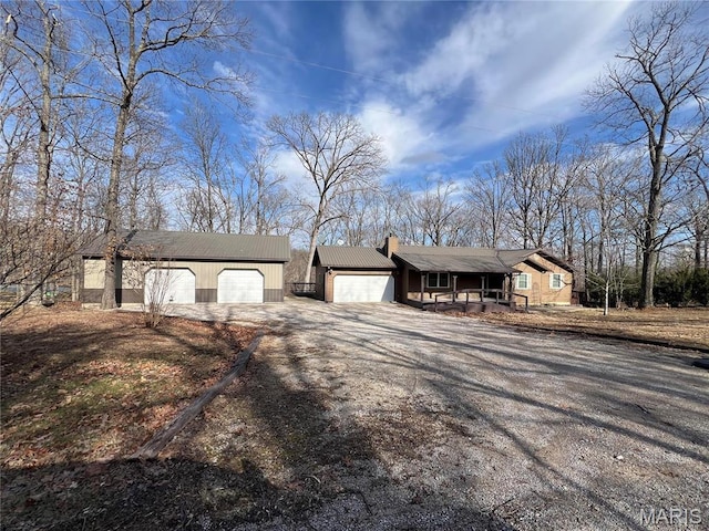 732 Woodridge Ln, Perryville, MO 63775 - view of front facade featuring driveway, a chimney, a garage, covered porch, and an outdoor structure