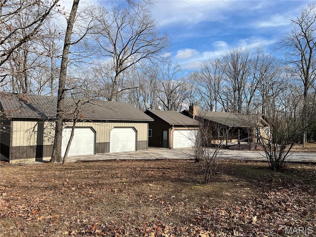 732 Woodridge Ln, Perryville, MO 63775 - view of front of property with driveway, metal roof, a garage, and a chimney