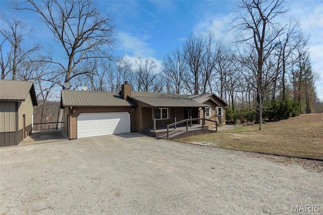 732 Woodridge Ln, Perryville, MO 63775 - ranch-style home featuring a garage, dirt driveway, covered porch, a chimney, and metal roof