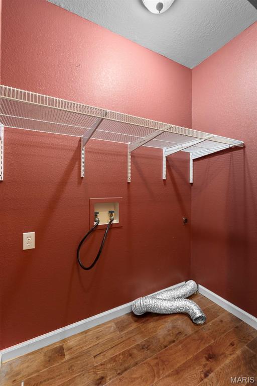 732 Woodridge Ln, Perryville, MO 63775 - laundry room featuring wood finished floors, washer hookup, and baseboards