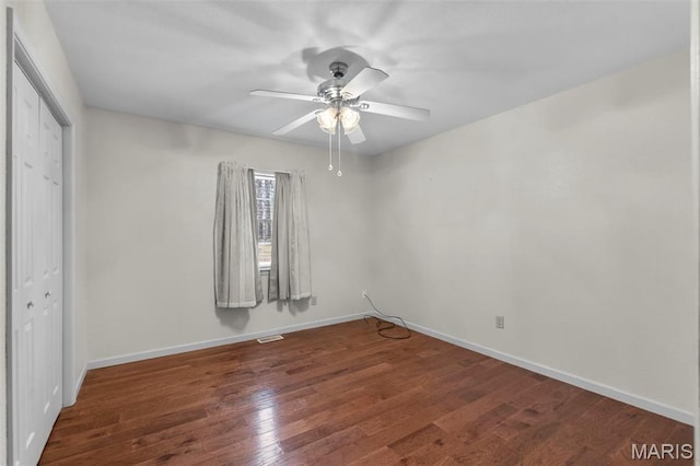 732 Woodridge Ln, Perryville, MO 63775 - unfurnished bedroom featuring wood finished floors, baseboards, a closet, and ceiling fan