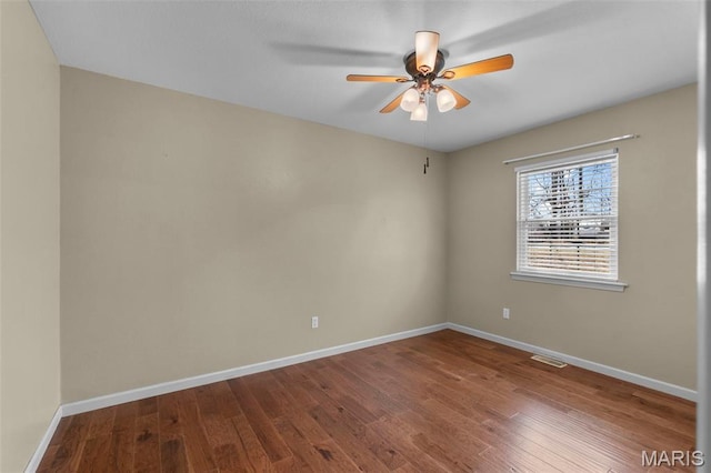 732 Woodridge Ln, Perryville, MO 63775 - spare room featuring ceiling fan, baseboards, and dark wood-style floors