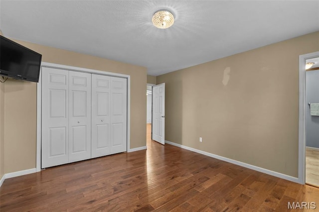 732 Woodridge Ln, Perryville, MO 63775 - unfurnished bedroom with wood finished floors, baseboards, and a closet